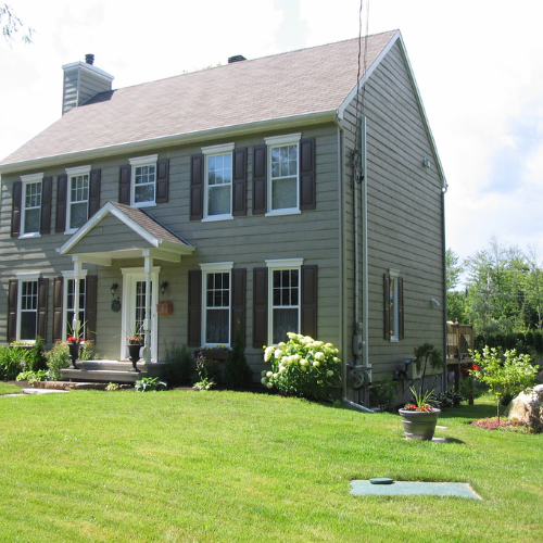 House with an  Ecoflo biofilter lid on the lawn.